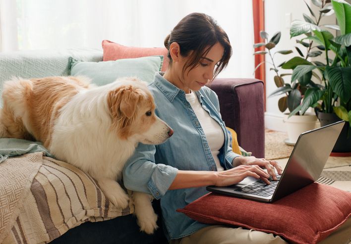 Someone working through figures on a laptop at home