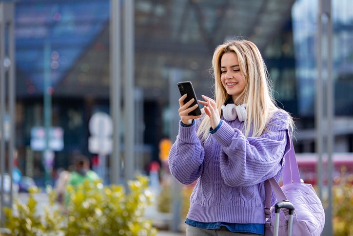 Someone checking their phone on a city street